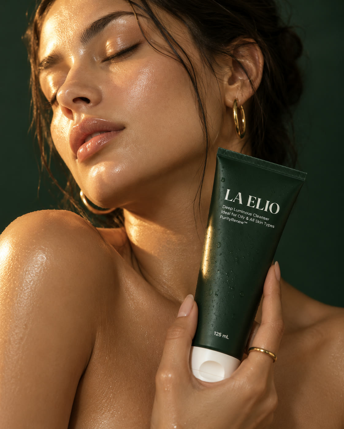 Model with LA ELIO cleanser in golden light